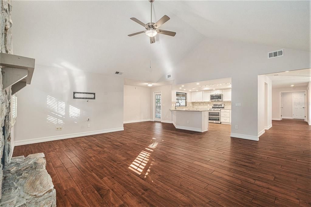 Empty room, Interior, Kitchen, Recessed Lighting, Stainless Steel Appliances, Wood Texture Flooring