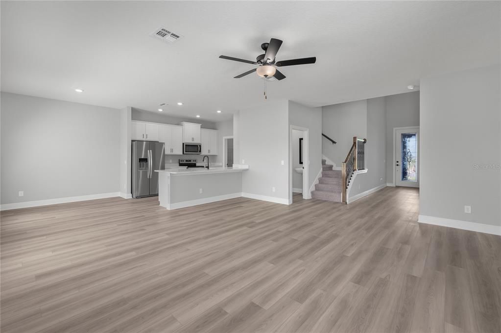 Empty room, Interior, Kitchen, Recessed Lighting, Stainless Steel Appliances, Wood Texture Flooring