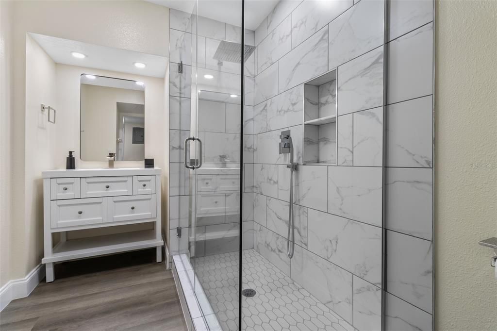 Bathroom, Glass Shower, Interior, Marble Walls, Recessed Lighting, Wood Texture Flooring