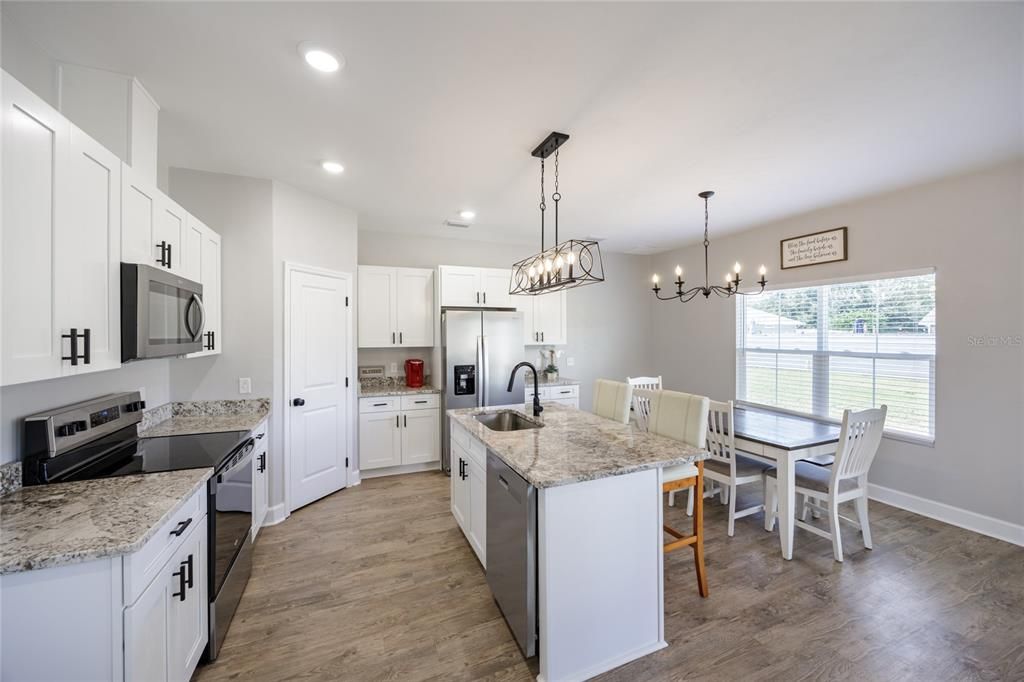 Dining room, Interior, Kitchen, Pendant Lights, Recessed Lighting, Stainless Steel Appliances, Wood Texture Flooring