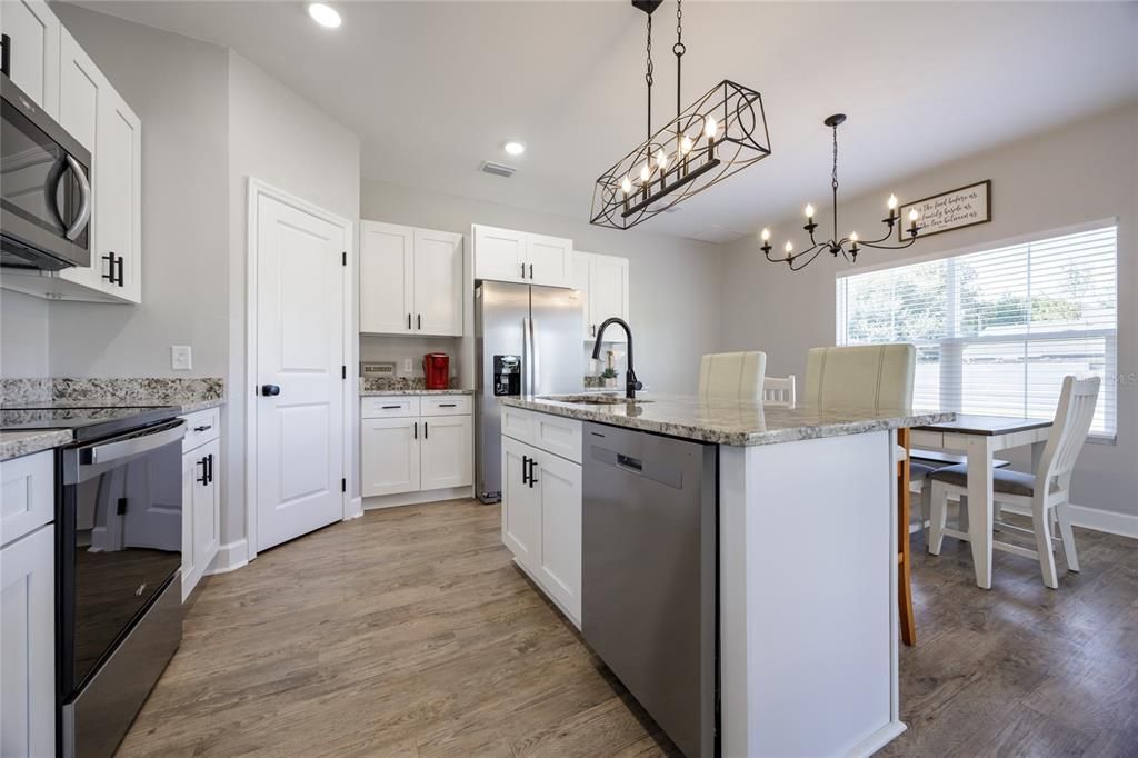 Dining room, Interior, Kitchen, Pendant Lights, Recessed Lighting, Stainless Steel Appliances, Wood Texture Flooring