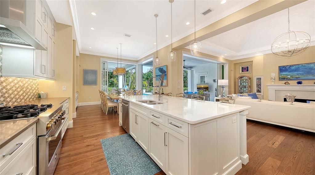 Chandelier, Dining room, Interior, Kitchen, Living room, Pendant Lights, Recessed Lighting, Stainless Steel Appliances, Wood Texture Flooring