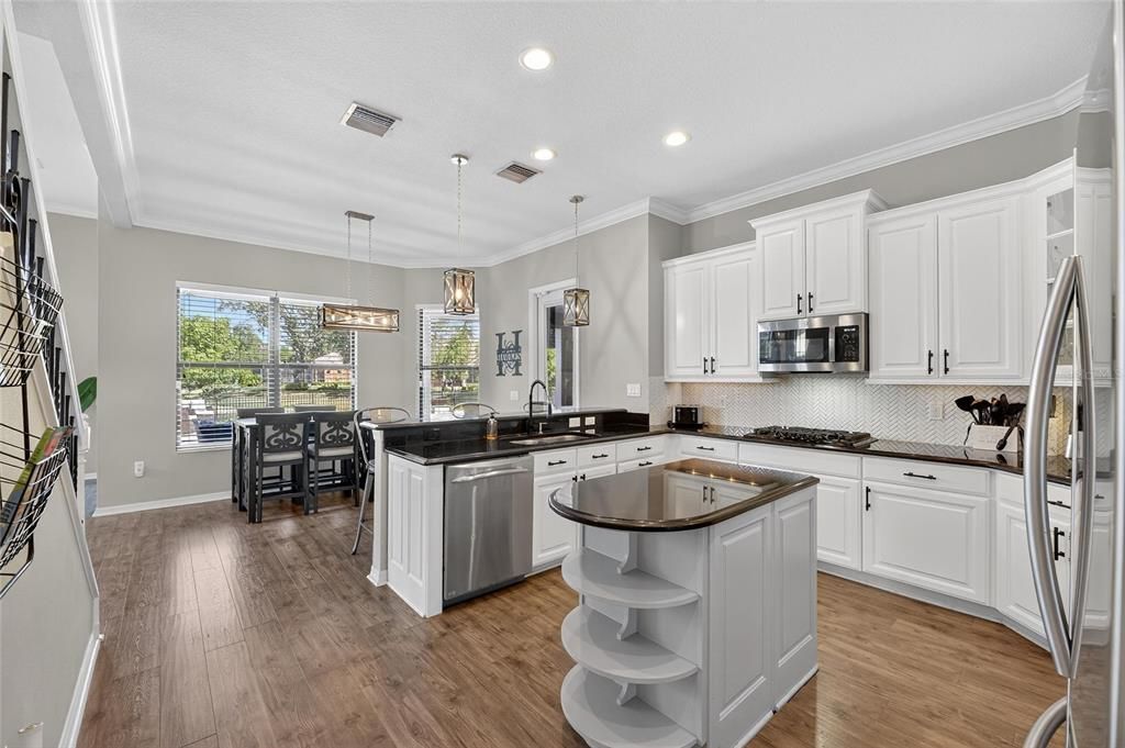 Dining room, Interior, Kitchen, Pendant Lights, Recessed Lighting, Stainless Steel Appliances, Wood Texture Flooring
