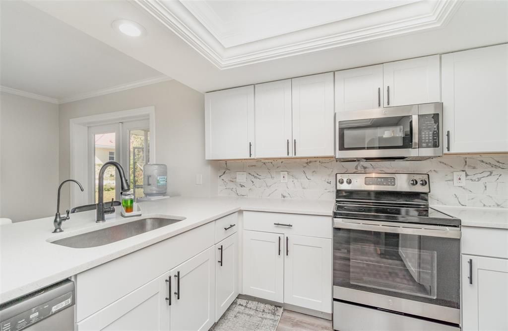 Interior, Kitchen, Marble Walls, Recessed Lighting, Stainless Steel Appliances, Wood Texture Flooring