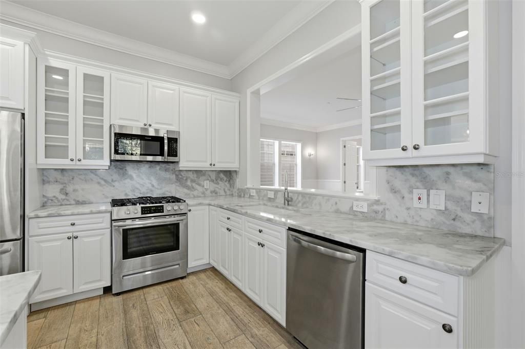 Interior, Kitchen, Marble Walls, Recessed Lighting, Stainless Steel Appliances, Wood Texture Flooring