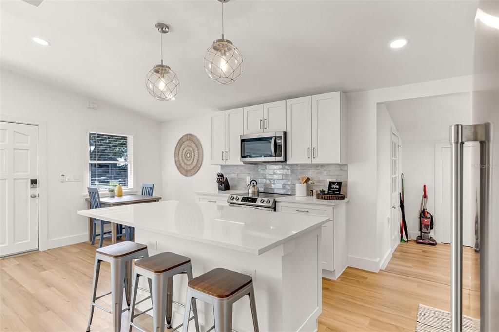 Dining room, Interior, Kitchen, Pendant Lights, Recessed Lighting, Stainless Steel Appliances, Wood Texture Flooring