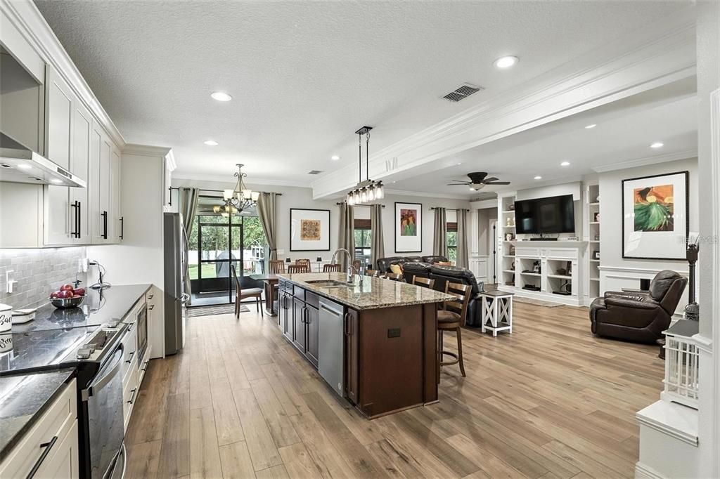 Chandelier, Dining room, Fireplace, Interior, Kitchen, Living room, Pendant Lights, Recessed Lighting, Wood Texture Flooring