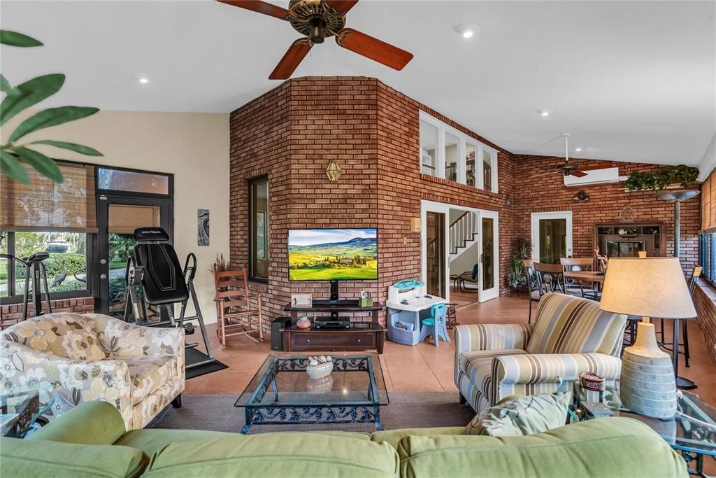 Dining room, Fireplace, Fitness Equipment, Interior, Living room, Recessed Lighting, Stone Walls