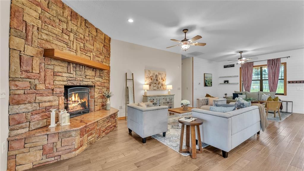 Dining room, Fireplace, Interior, Living room, Recessed Lighting, Stone Walls, Wood Texture Flooring