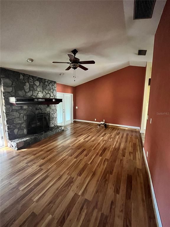Empty room, Fireplace, Interior, Recessed Lighting, Stone Walls, Wood Texture Flooring