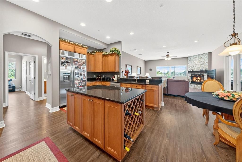 Fireplace, Interior, Kitchen, Living room, Pendant Lights, Recessed Lighting, Stainless Steel Appliances, Wood Texture Flooring