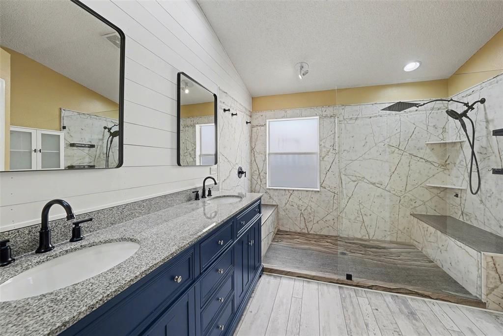 Bathroom, Dual Sink Vanities, Interior, Marble Walls, Recessed Lighting, Wood Texture Flooring
