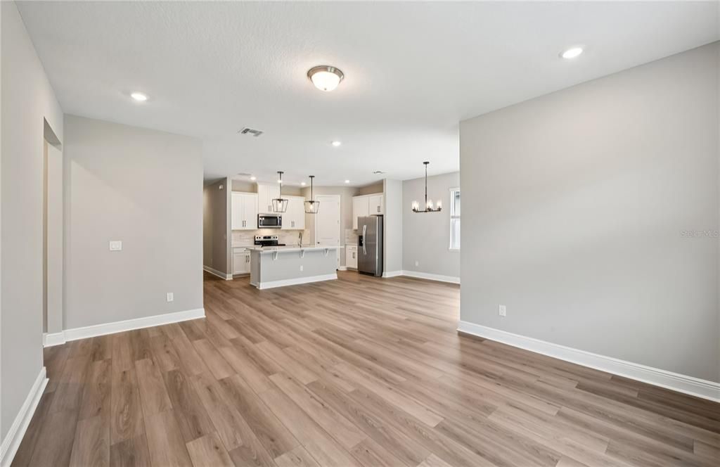 Empty room, Interior, Kitchen, Pendant Lights, Recessed Lighting, Stainless Steel Appliances, Wood Texture Flooring