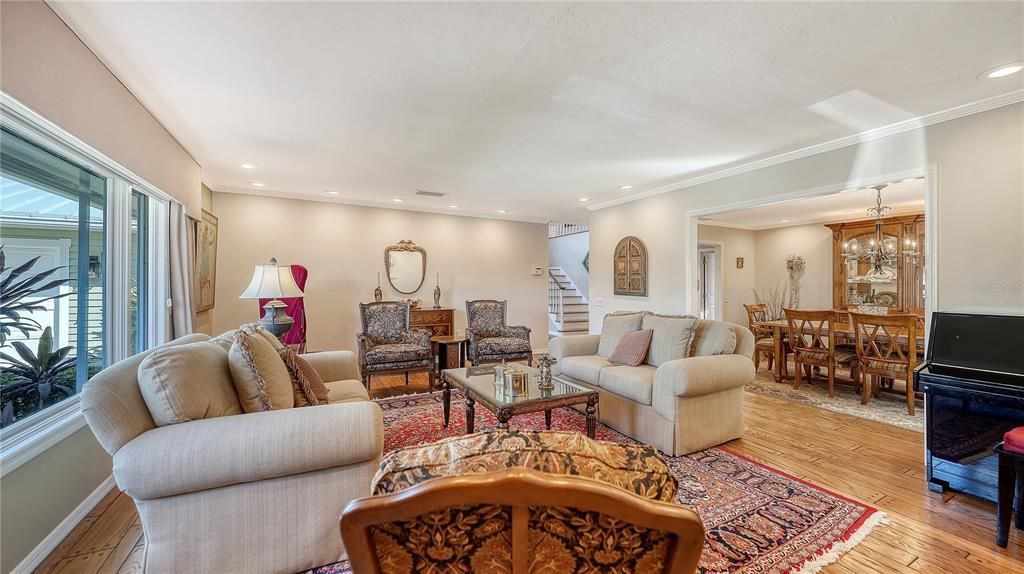 Chandelier, Dining room, Interior, Living room, Piano, Recessed Lighting, Wood Texture Flooring