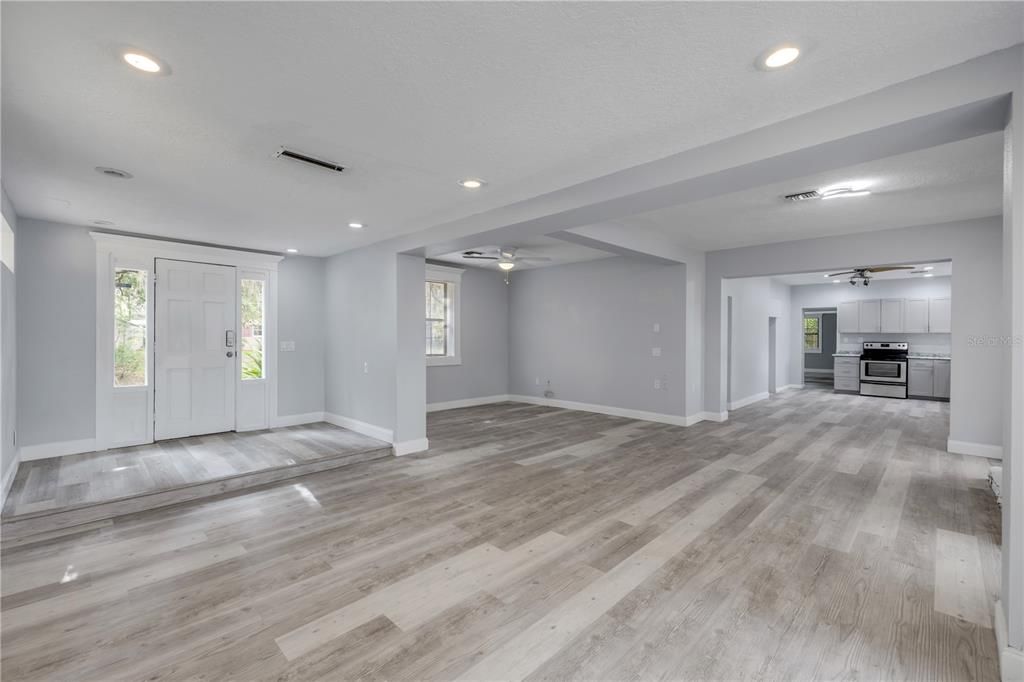 Empty room, Interior, Kitchen, Recessed Lighting, Stainless Steel Appliances, Wood Texture Flooring
