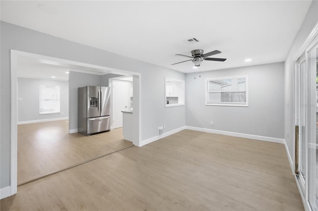 Empty room, Interior, Kitchen, Recessed Lighting, Stainless Steel Appliances, Wood Texture Flooring
