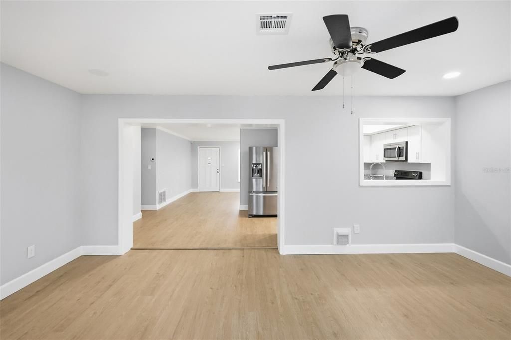 Empty room, Interior, Kitchen, Recessed Lighting, Stainless Steel Appliances, Wood Texture Flooring