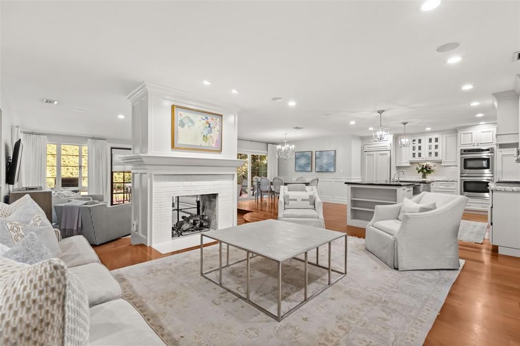 Chandelier, Dining room, Fireplace, Interior, Kitchen, Living room, Pendant Lights, Recessed Lighting, Stainless Steel Appliances, Wood Texture Flooring