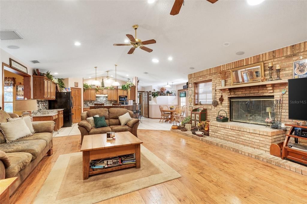 Dining room, Fireplace, Interior, Kitchen, Living room, Pendant Lights, Recessed Lighting, Stainless Steel Appliances, Stone Walls, Wood Texture Flooring, Wooden Walls