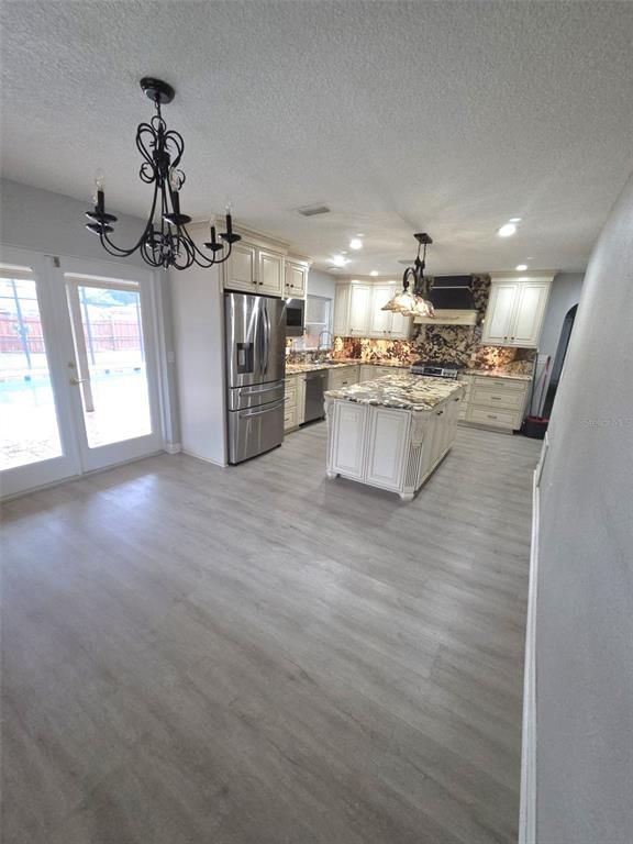 Chandelier, Interior, Kitchen, Pendant Lights, Recessed Lighting, Stainless Steel Appliances, Wood Texture Flooring