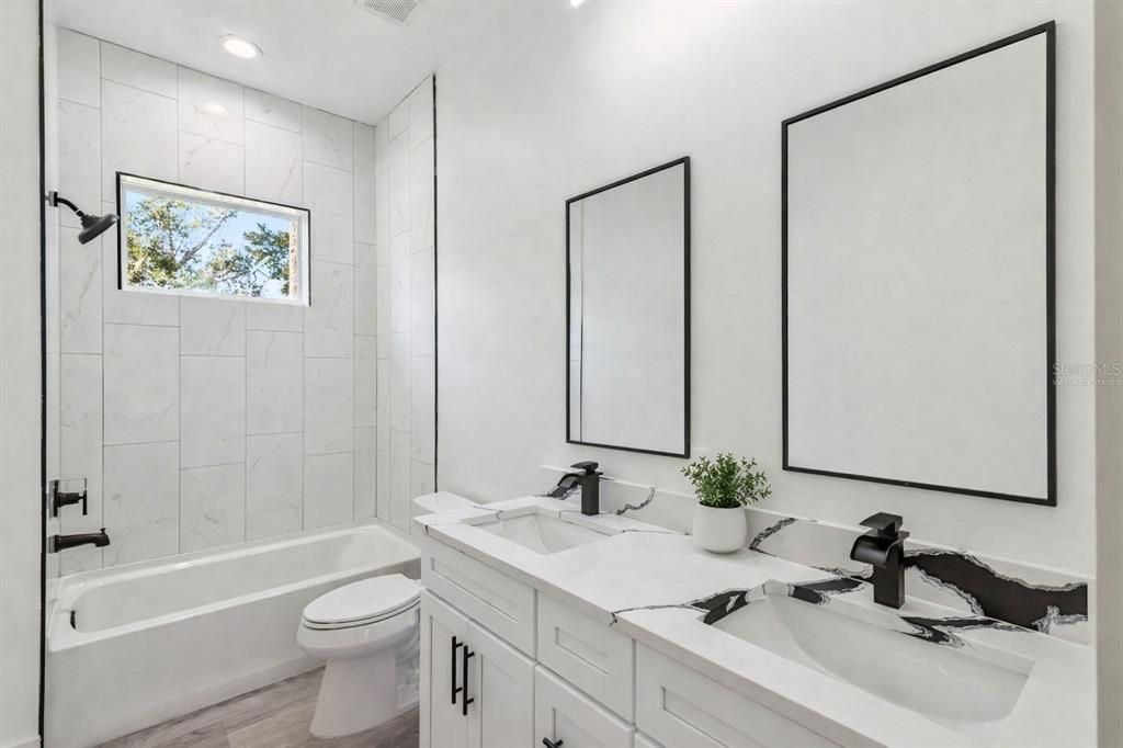 Bathroom, Dual Sink Vanities, Interior, Marble Walls, Recessed Lighting, Wood Texture Flooring