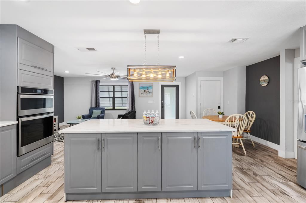 Dining room, Interior, Kitchen, Pendant Lights, Recessed Lighting, Stainless Steel Appliances, Wood Texture Flooring
