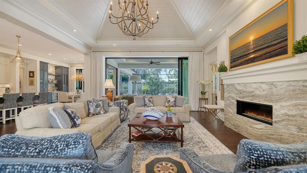 Chandelier, Dining room, Fireplace, Interior, Living room, Pendant Lights, Recessed Lighting, Wood Texture Flooring