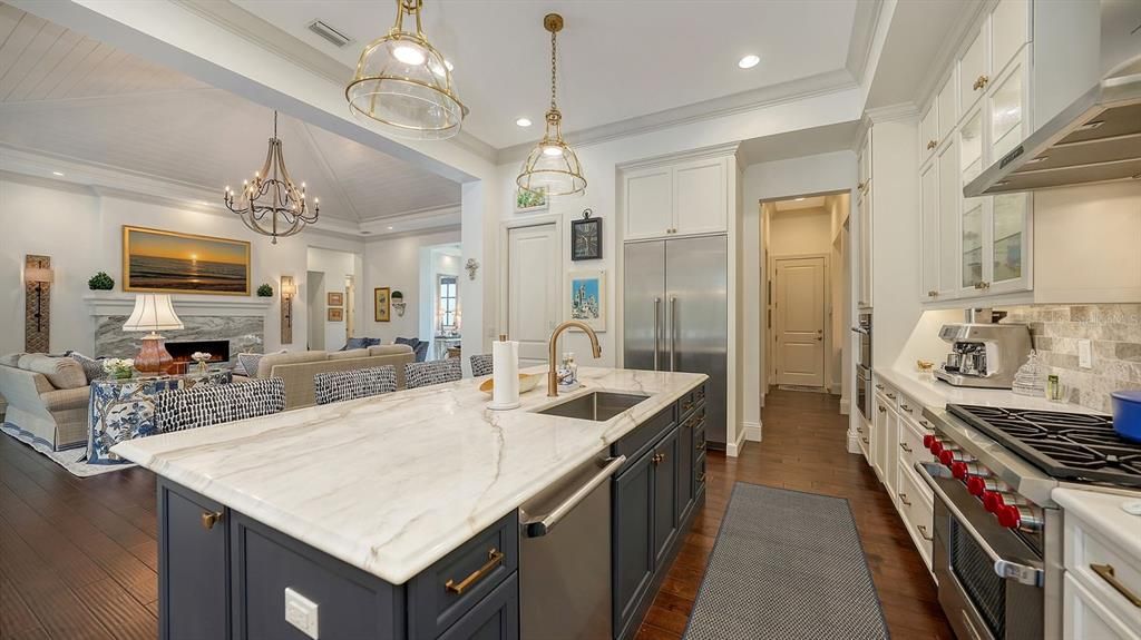 Chandelier, Fireplace, Interior, Kitchen, Living room, Pendant Lights, Recessed Lighting, Stainless Steel Appliances, Wood Texture Flooring