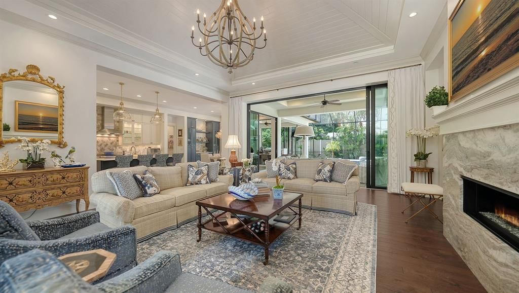 Chandelier, Fireplace, Interior, Kitchen, Living room, Pendant Lights, Recessed Lighting, Wood Texture Flooring