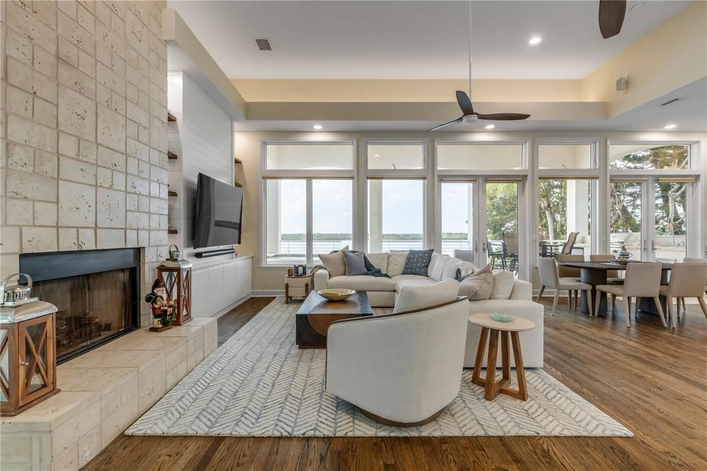 Dining room, Fireplace, Interior, Living room, Recessed Lighting, Water, Wood Texture Flooring