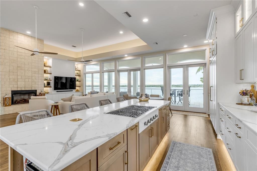 Dining room, Fireplace, Interior, Kitchen, Living room, Pendant Lights, Recessed Lighting, Stone Walls, Water, Wood Texture Flooring