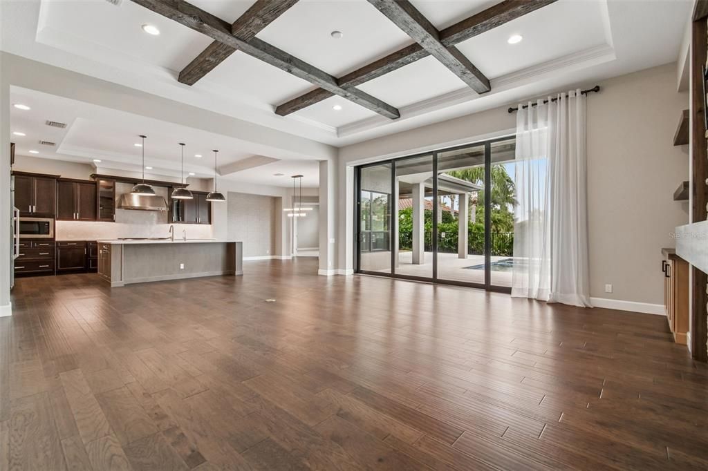 Empty room, Interior, Kitchen, Pendant Lights, Recessed Lighting, Stainless Steel Appliances, Wooden Beams, Wood Texture Flooring