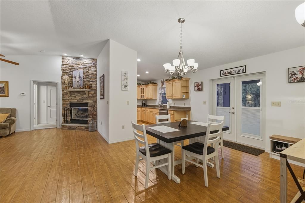 Chandelier, Dining room, Fireplace, Interior, Kitchen, Recessed Lighting, Stone Walls, Wood Texture Flooring