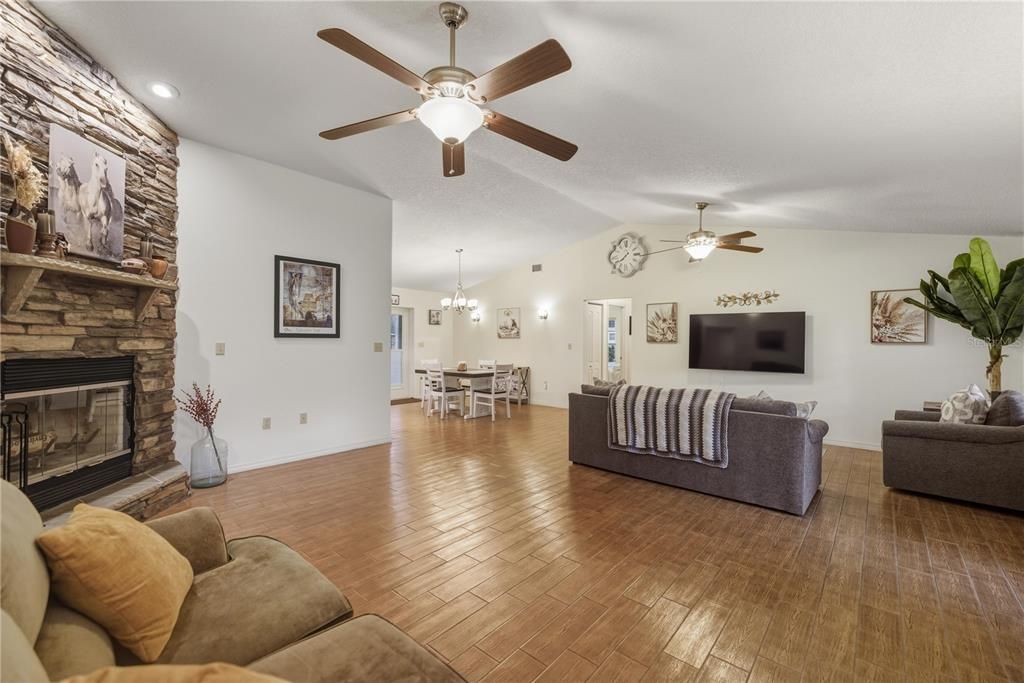 Chandelier, Dining room, Fireplace, Interior, Living room, Recessed Lighting, Stone Walls, Wood Texture Flooring