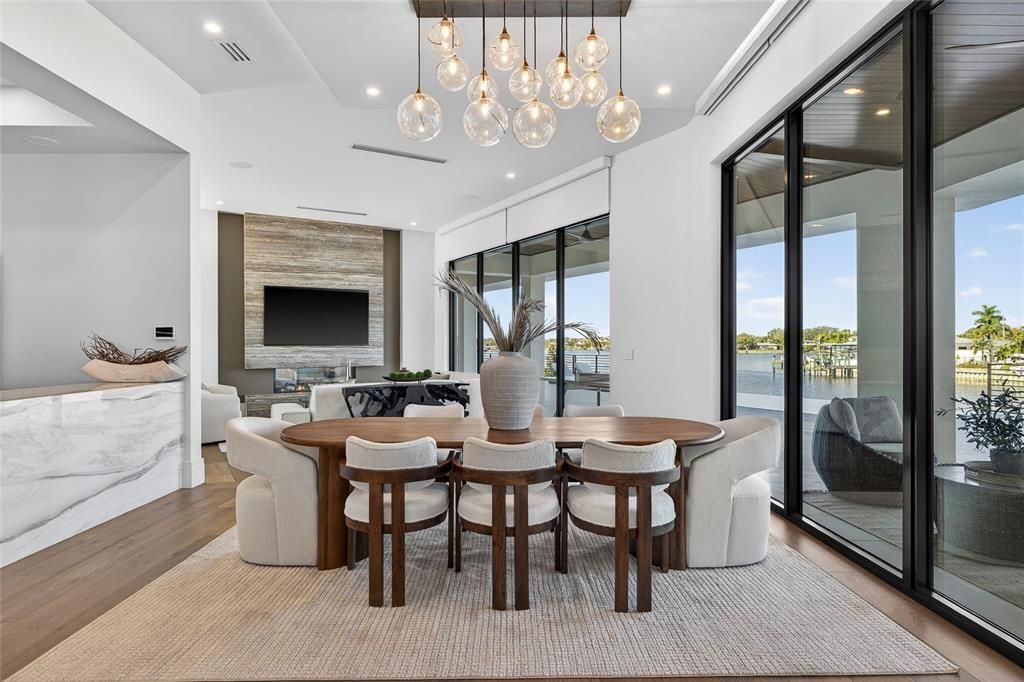 Dining room, Fireplace, Interior, Living room, Pendant Lights, Recessed Lighting, Water, Wood Texture Flooring