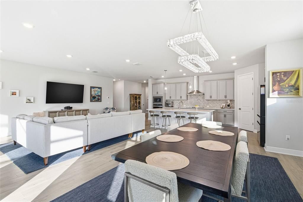 Chandelier, Dining room, Interior, Kitchen, Living room, Pendant Lights, Recessed Lighting, Stainless Steel Appliances, Wood Texture Flooring