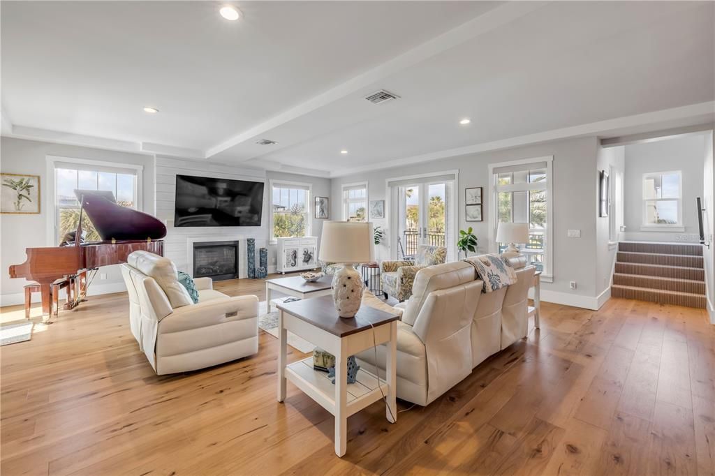 Fireplace, Interior, Living room, Piano, Recessed Lighting, Wood Texture Flooring