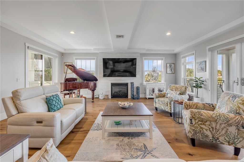 Fireplace, Interior, Living room, Piano, Recessed Lighting, Wood Texture Flooring