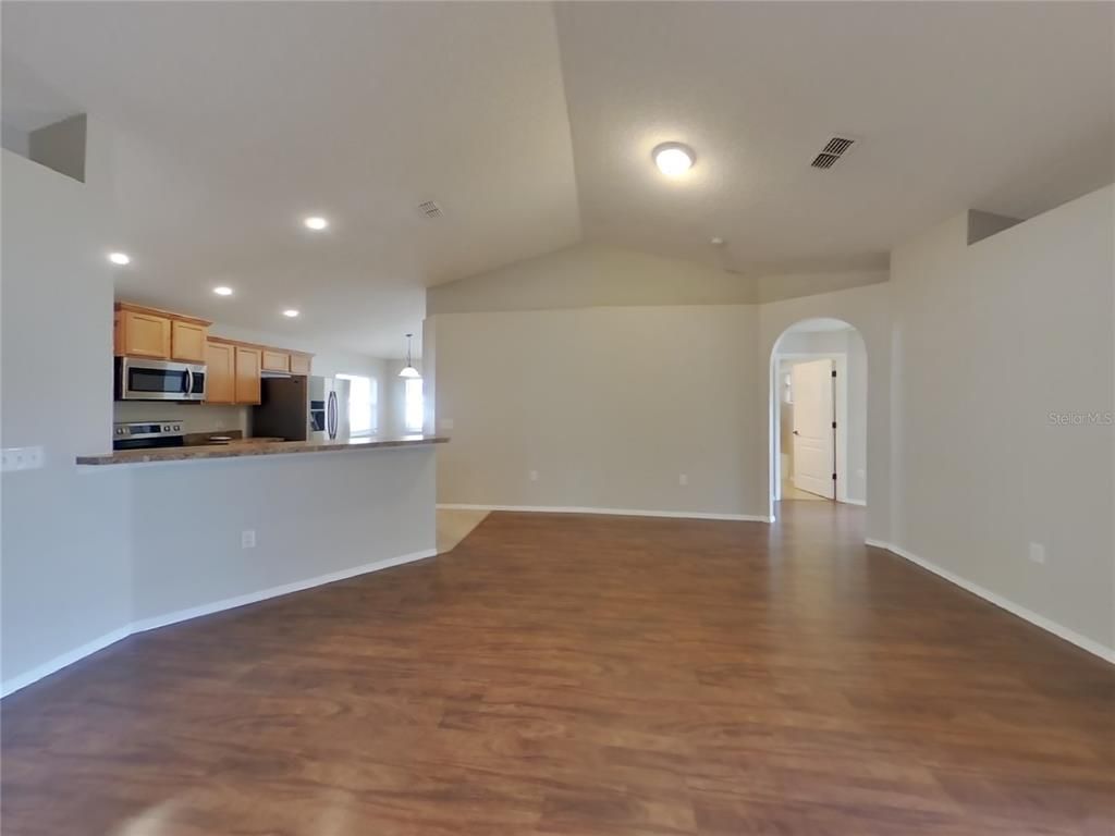 Empty room, Interior, Kitchen, Pendant Lights, Recessed Lighting, Stainless Steel Appliances, Wood Texture Flooring
