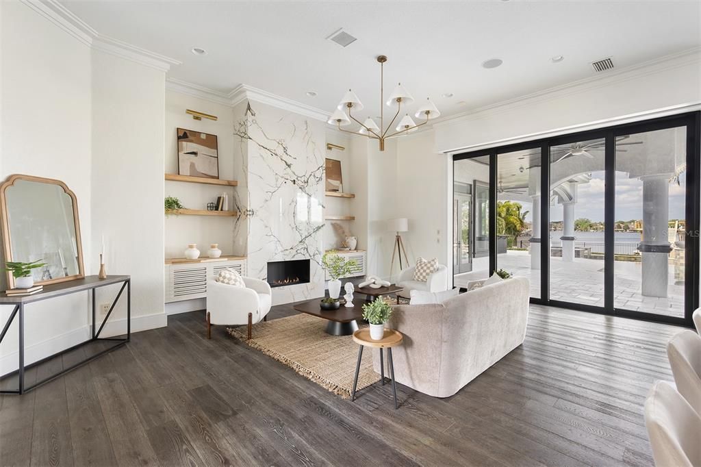 Chandelier, Fireplace, Interior, Living room, Marble Walls, Recessed Lighting, Wood Texture Flooring