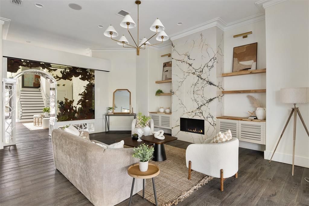 Chandelier, Fireplace, Interior, Living room, Marble Walls, Recessed Lighting, Wood Texture Flooring