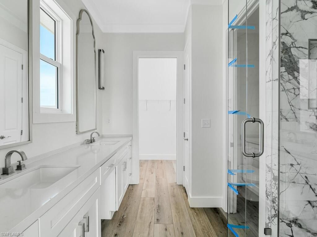 Bathroom, Dual Sink Vanities, Glass Shower, Interior, Marble Walls, Wood Texture Flooring