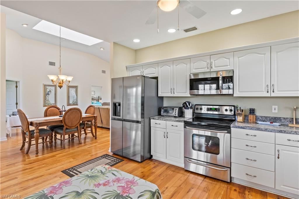 Chandelier, Dining room, Interior, Kitchen, Pendant Lights, Recessed Lighting, Stainless Steel Appliances, Wood Texture Flooring