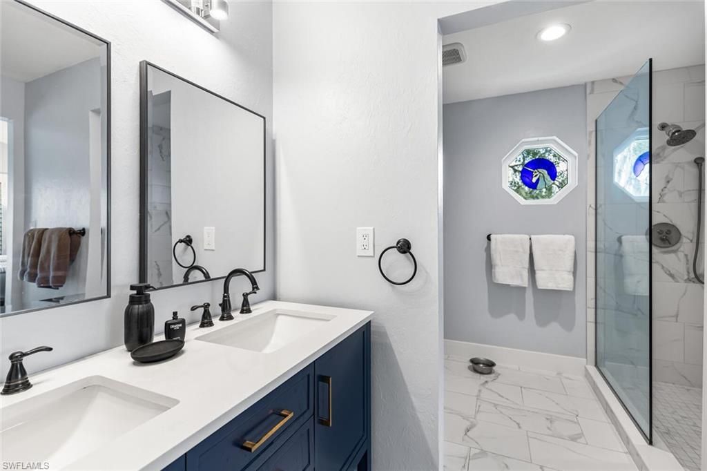 Bathroom, Dual Sink Vanities, Glass Shower, Interior, Marble, Marble Walls, Recessed Lighting