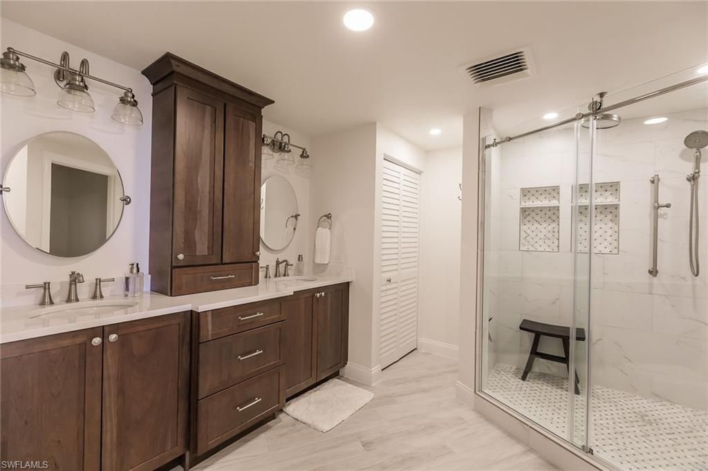 Bathroom, Dual Sink Vanities, Glass Shower, Interior, Marble Walls, Recessed Lighting, Wood Texture Flooring