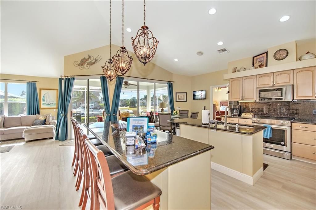 Chandelier, Dining room, Interior, Kitchen, Living room, Pendant Lights, Recessed Lighting, Stainless Steel Appliances, Wood Texture Flooring