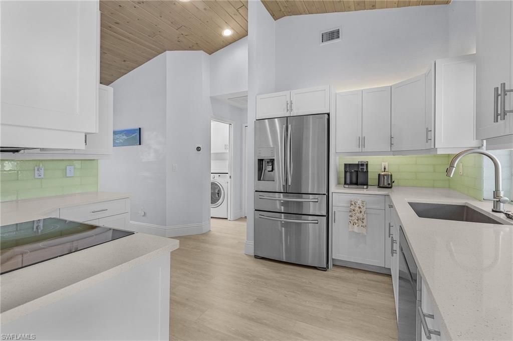 Interior, Kitchen, Recessed Lighting, Stainless Steel Appliances, Washer, Wooden Ceilings, Wood Texture Flooring