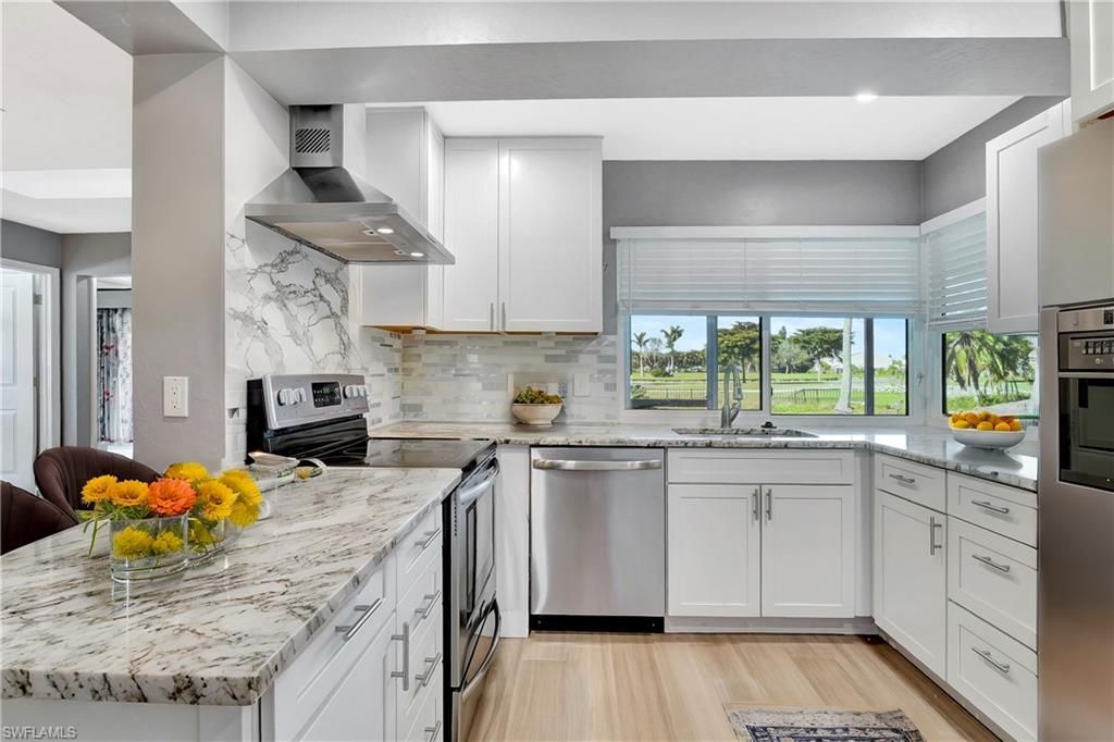 Interior, Kitchen, Marble Walls, Recessed Lighting, Stainless Steel Appliances, Wood Texture Flooring