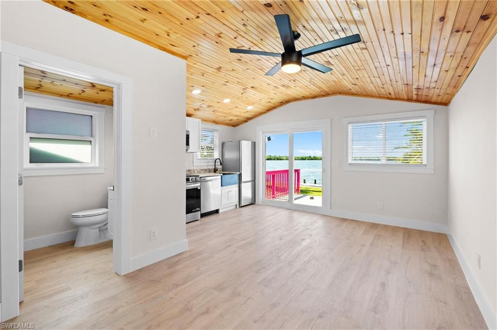 Empty room, Interior, Kitchen, Recessed Lighting, Stainless Steel Appliances, Wooden Ceilings, Wood Texture Flooring