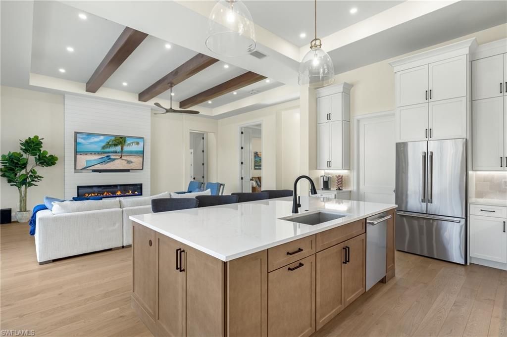 Fireplace, Interior, Kitchen, Living room, Pendant Lights, Recessed Lighting, Stainless Steel Appliances, Wooden Beams, Wood Texture Flooring